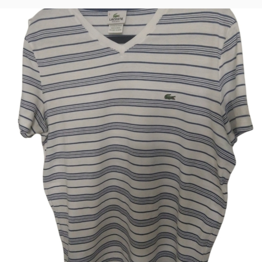 Blue and white strip Lacoste T-shrit. Size 5 in great condition.